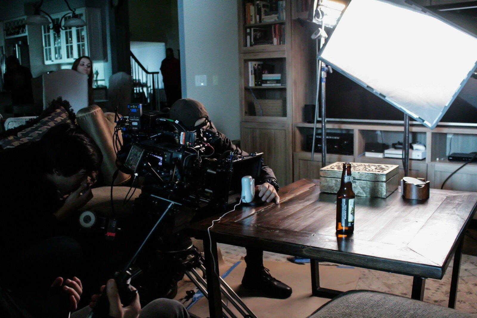 man taking a video on table near studio lamp